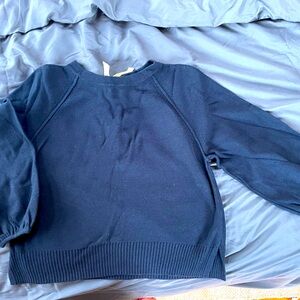 Really sweet navy blue sweater with bell sleeves and white bow on back.